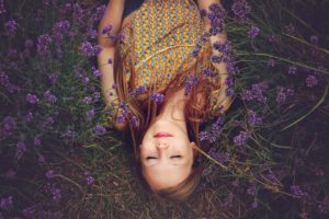 Girl relaxing in a field of lavender